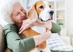 woman holding dog smiling