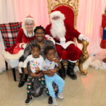 A KKids family visits Santa and Mrs. Claus, volunteer Ruthie Coleman in Louisville.